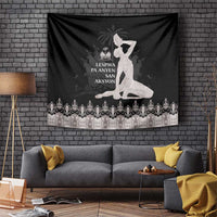 Black tapestry with seated woman figure and silver ornate band on bottom edge