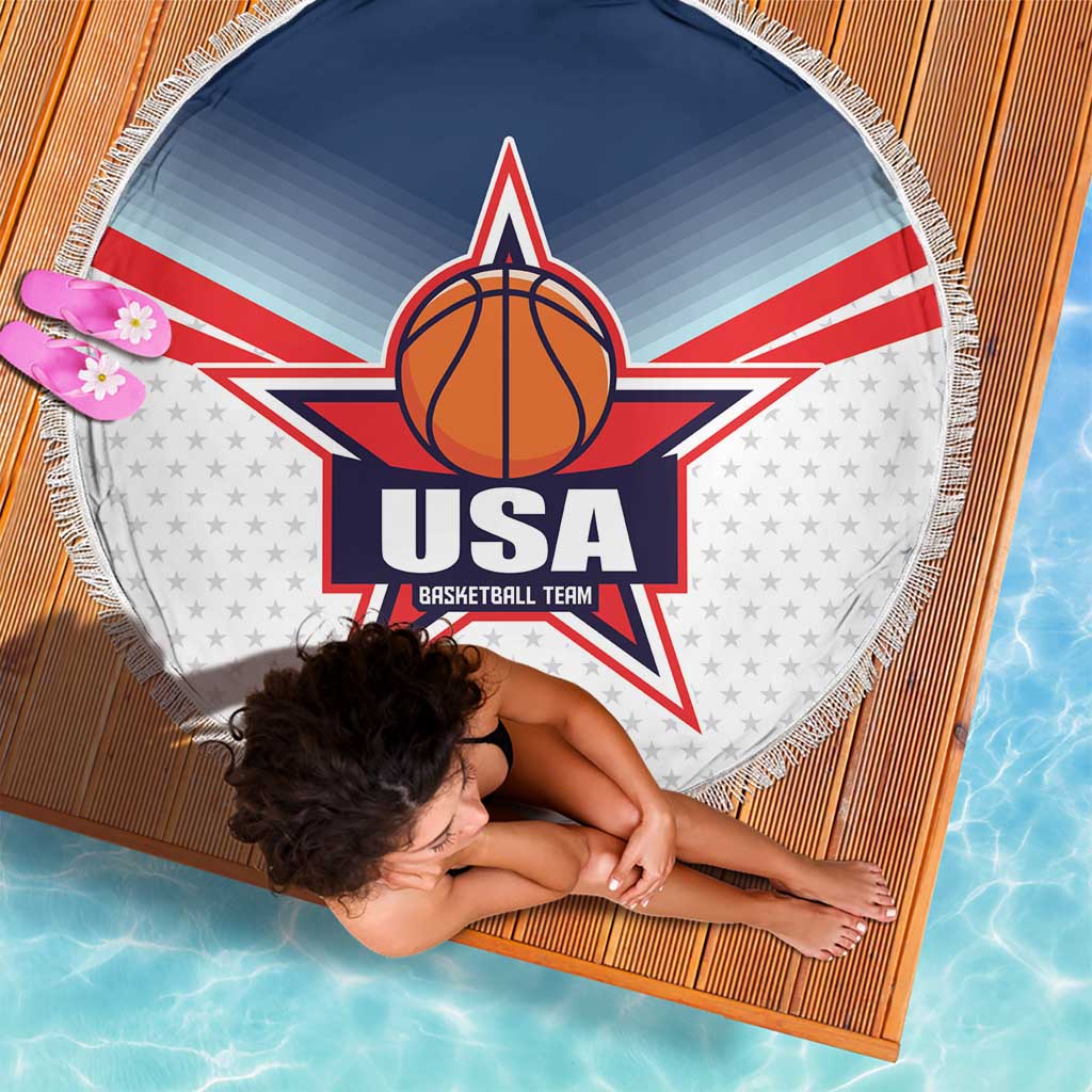 Round beach blanket with USA basketball star logo, fringed border, laid on wood deck