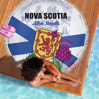 Round beach blanket with Nova Scotia crest and flag stripes, fringed border