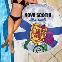 Round Nova Scotia beach blanket with blue-and-white flag design and fringe border