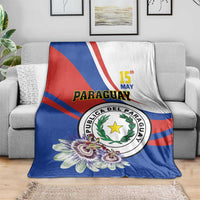 Paraguay Independence Day blanket draped on sofa, blue with emblem, flowers, red stripe