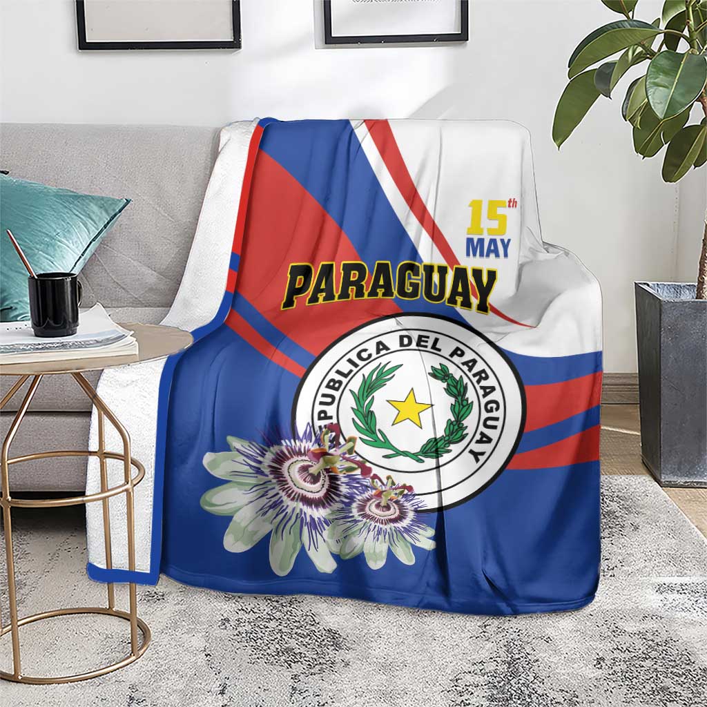 Paraguay Independence Day blanket on floor couch, blue with emblem and multi-color flowers