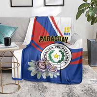 Paraguay Independence Day blanket on floor couch, blue with emblem and multi-color flowers