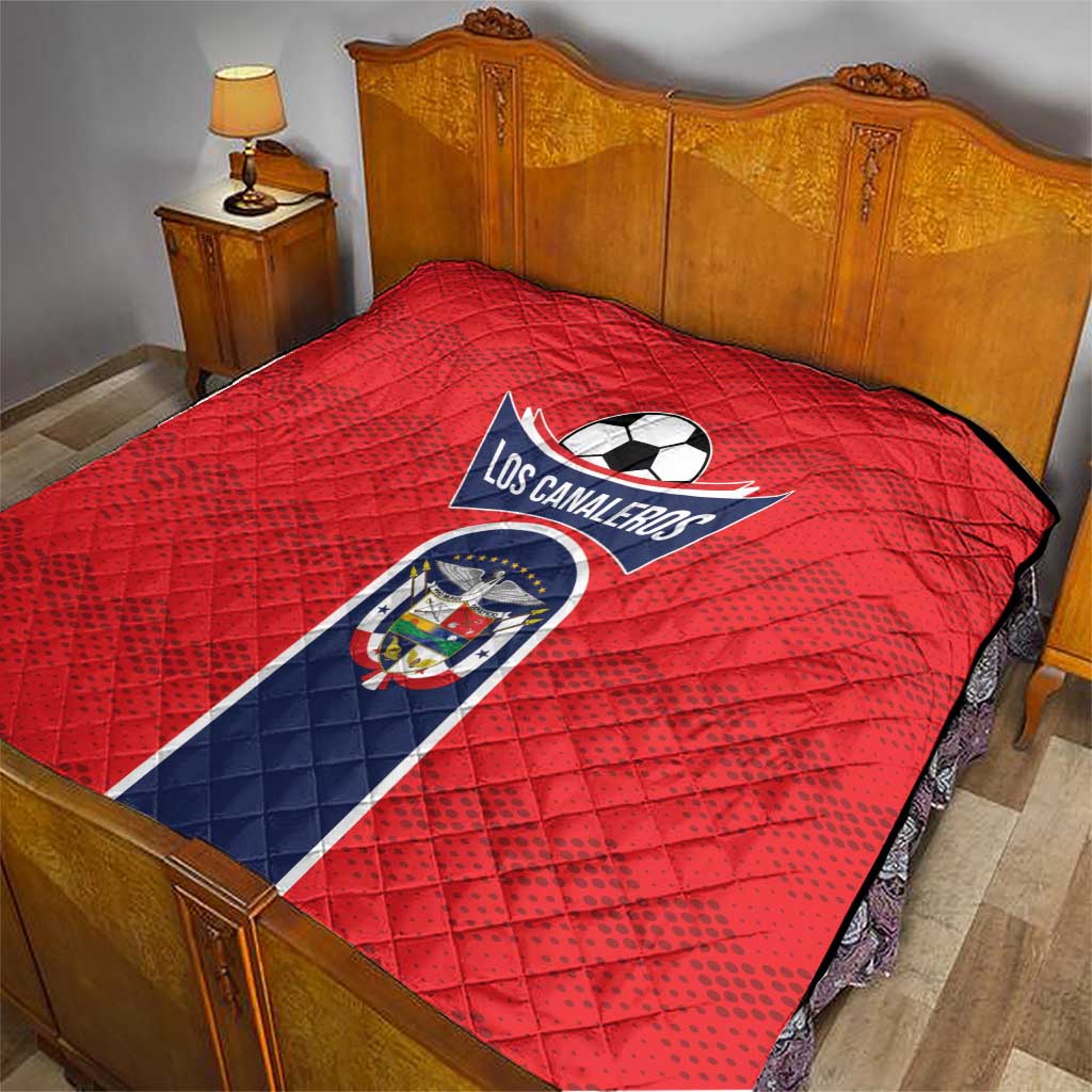 Red football quilt blanket with Los Canaleros crest on a bed, laid flat