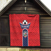 Red quilt blanket with Los Canaleros football logo and shield emblem, hanging
