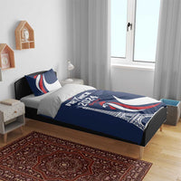 Blue duvet cover and two pillows with France 2024 Eiffel Tower and rooster graphics