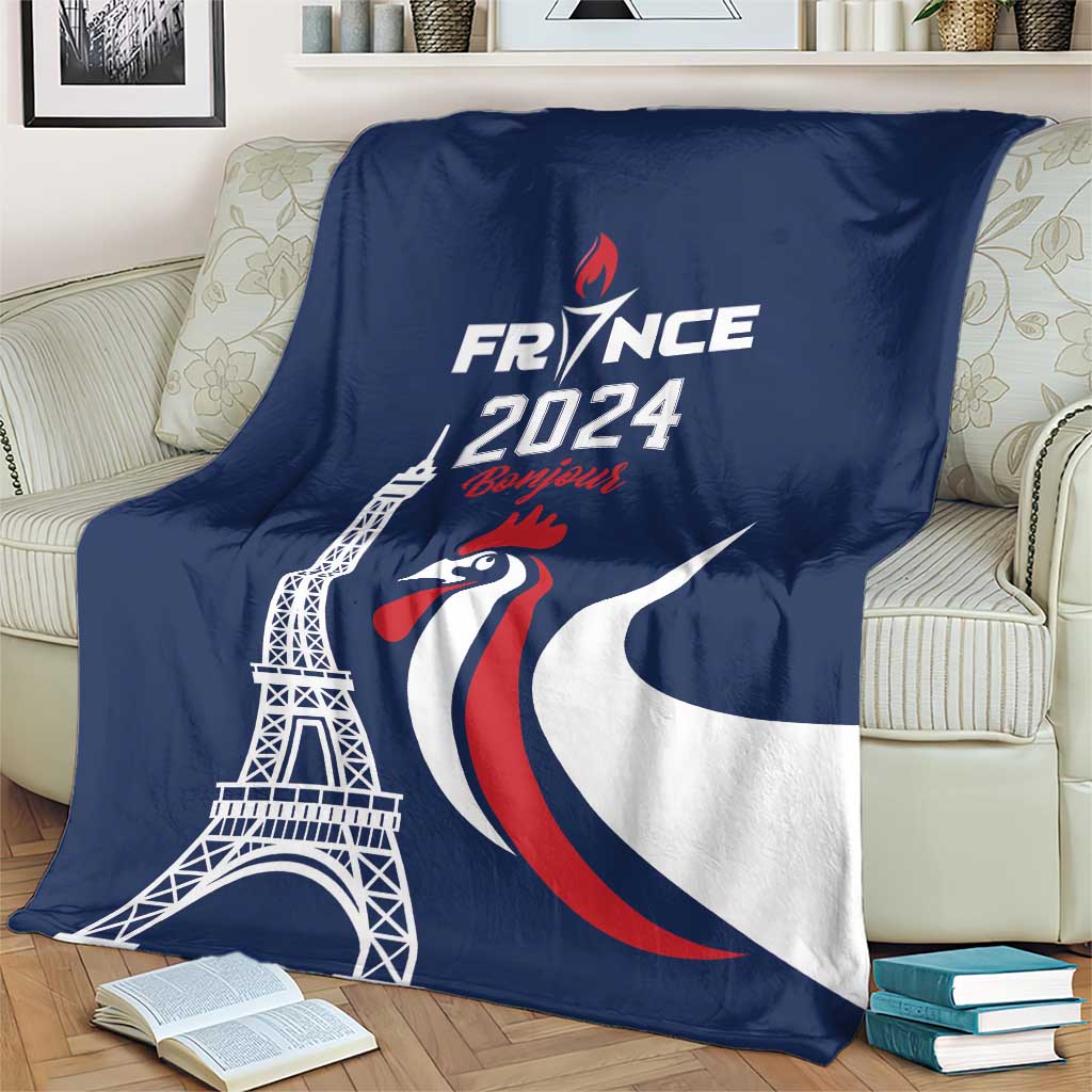 Blue throw blanket on sofa with Eiffel Tower, rooster emblem, and France 2024 text