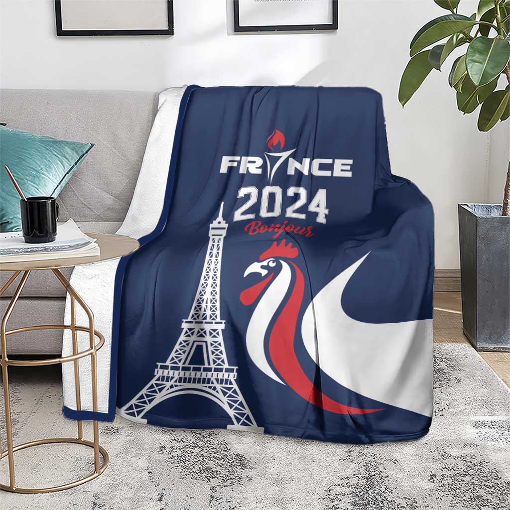 Blue blanket draped on armchair with Eiffel Tower and France 2024 rooster design