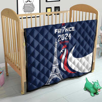 Blue France 2024 quilt blanket with Eiffel Tower and rooster graphic, on crib front