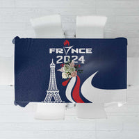 Blue printed tablecloth with Eiffel Tower and France-themed graphic in red and white.