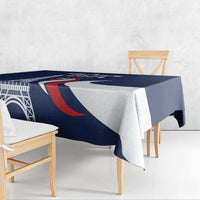 Blue rectangular tablecloth with Eiffel Tower design and red-and-white curved stripes.