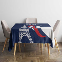 Blue tablecloth with large Eiffel Tower print and red-and-white wave shapes.