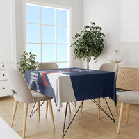 Blue France-themed tablecloth with Eiffel Tower motif and red-and-white swoosh pattern.