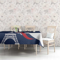 Blue printed tablecloth featuring Eiffel Tower and red-and-white curved stripes.