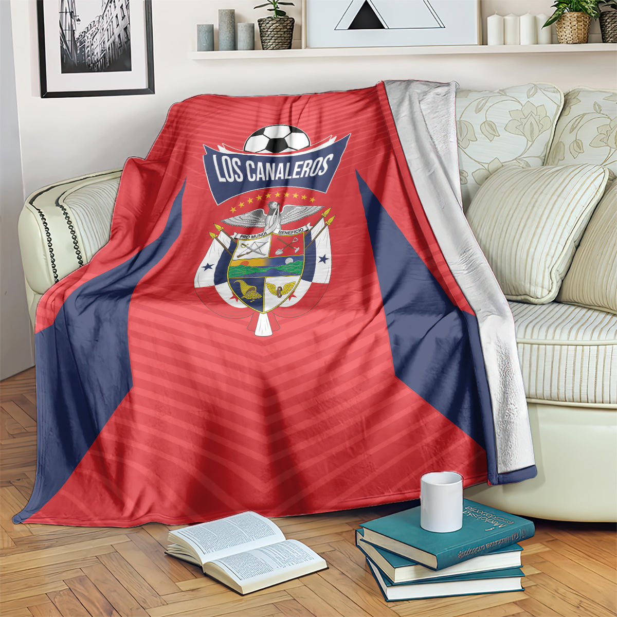 Red and navy football blanket with Los Canaleros logo, folded over an armchair