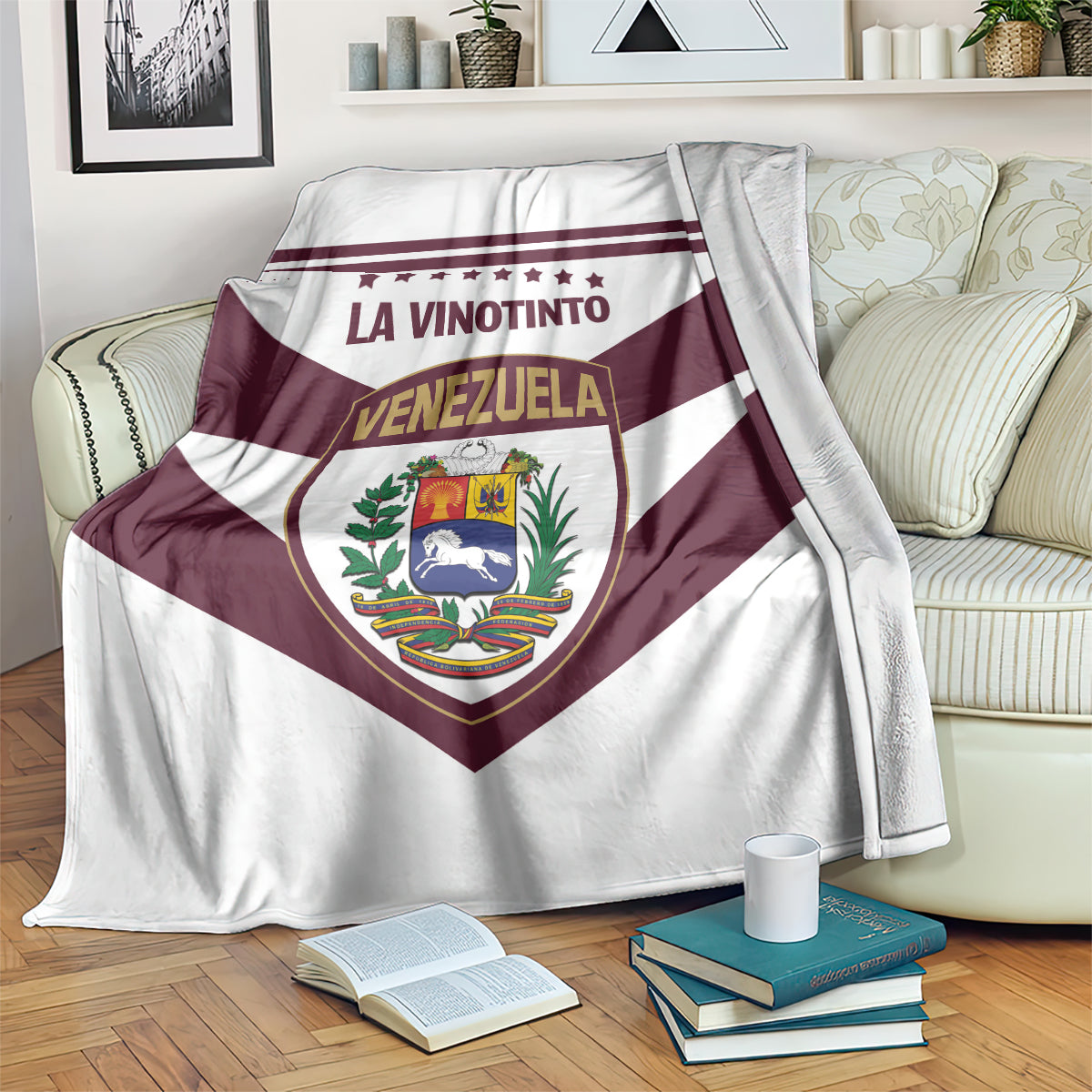 Football blanket spread on couch, maroon stripes and Venezuela crest in center