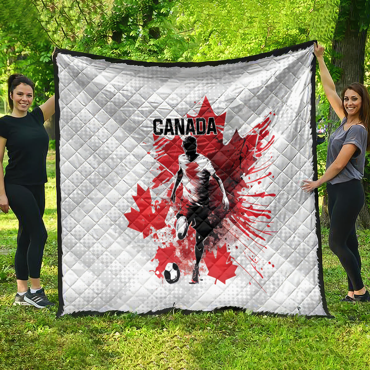 Large white quilted blanket draped outdoors, Canada soccer graphic with red maple leaf