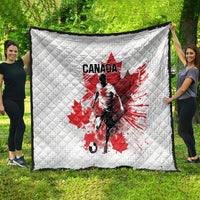 Large white quilted blanket draped outdoors, Canada soccer graphic with red maple leaf