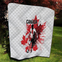 White quilted throw blanket with centered Canada soccer player and red maple leaf