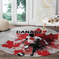Light gray round Canada soccer carpet featuring Canada wordmark, red maple leaf, soccer player