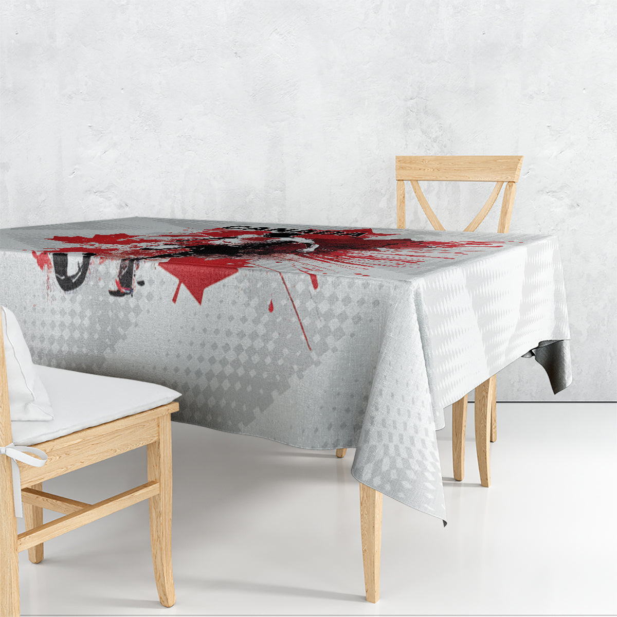 White tablecloth with Canada graphics: red splatter maple leaf and goalie silhouette