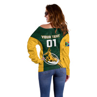 Women’s off-shoulder sweater back: YOUR TEXT 01, emblem centered on green-and-yellow blocks