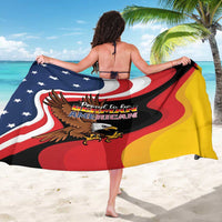 Black sarong with German-American eagle and flag graphic, worn as a beach wrap