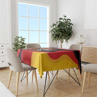 Eagle heritage tablecloth over dining table with red, yellow, and black flag pattern