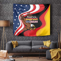 Eagle and flag wave tapestry with bold lettering and brown eagle, hanging on brick wall