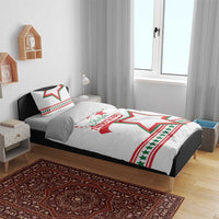 White bedding set on bed with “Italian American” and large green/red star on duvet