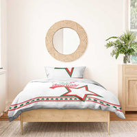 White bedding set on wooden bed with star and “Italian American” text on duvet