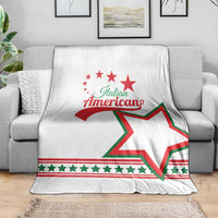 White blanket on sofa with Italian American wordmark and green-red star