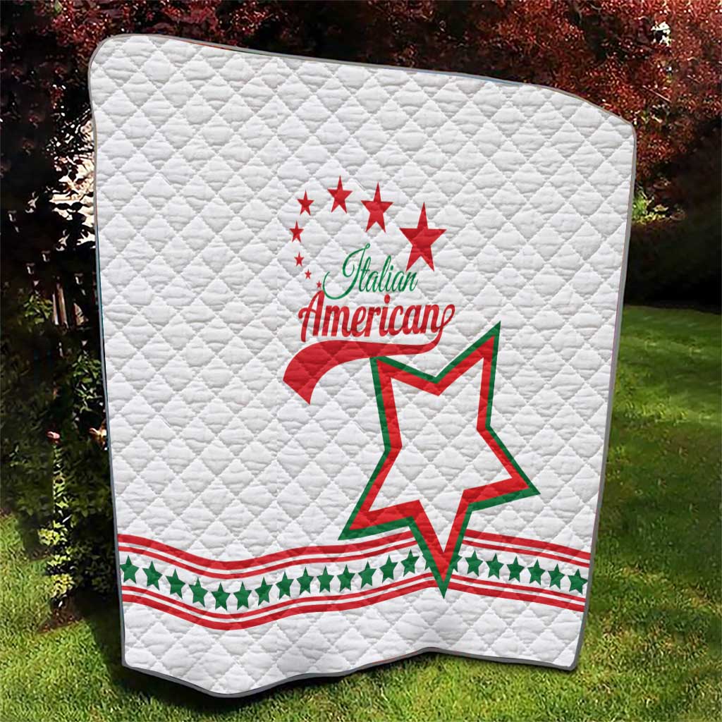 White quilt top view with Italian American logo, red stars and green star outline