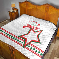 White quilt on bed with diamond quilting and Italian American emblem over star design