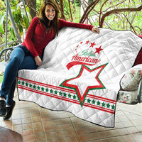 White quilt draped over couch with diamond quilting and Italian American emblem and green star