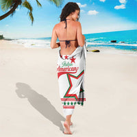 White sarong worn as wrap, Italian American text with red-green star on front