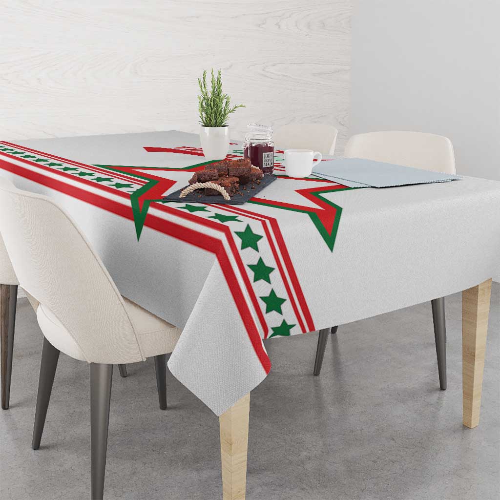 White tablecloth featuring red, green star pattern draped over square table
