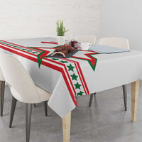White tablecloth featuring red, green star pattern draped over square table