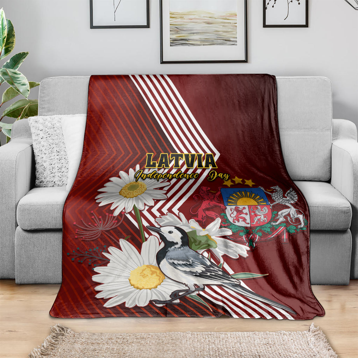 Red blanket on sofa with Latvia text, crest, wagtail bird, and daisy flowers