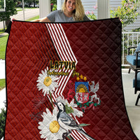 Red quilt featuring Latvian diagonal stripes, daisy flowers, crest, and bird motif