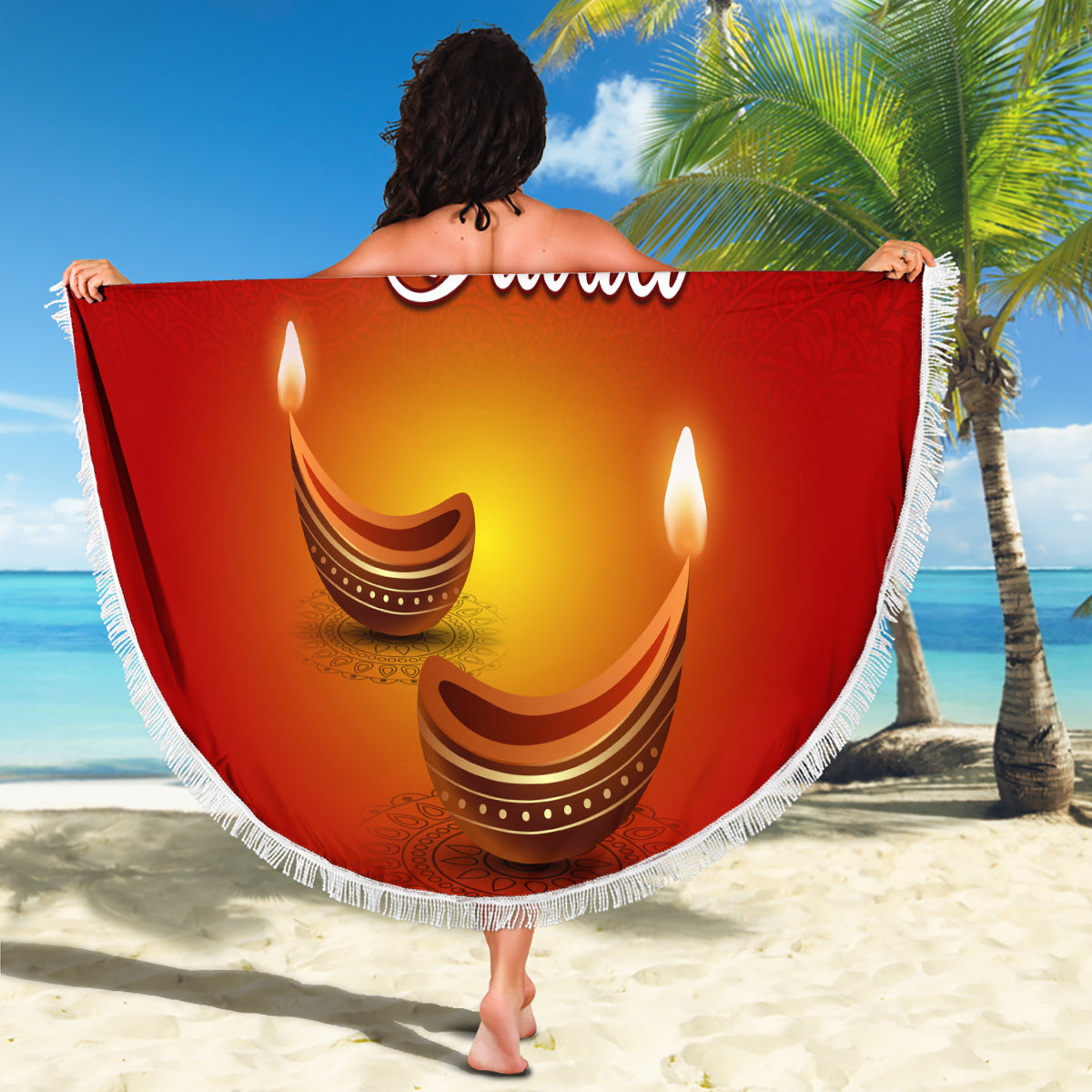 Red round Diwali beach blanket held on beach, paisley diya lamps and 'Happy Diwali'