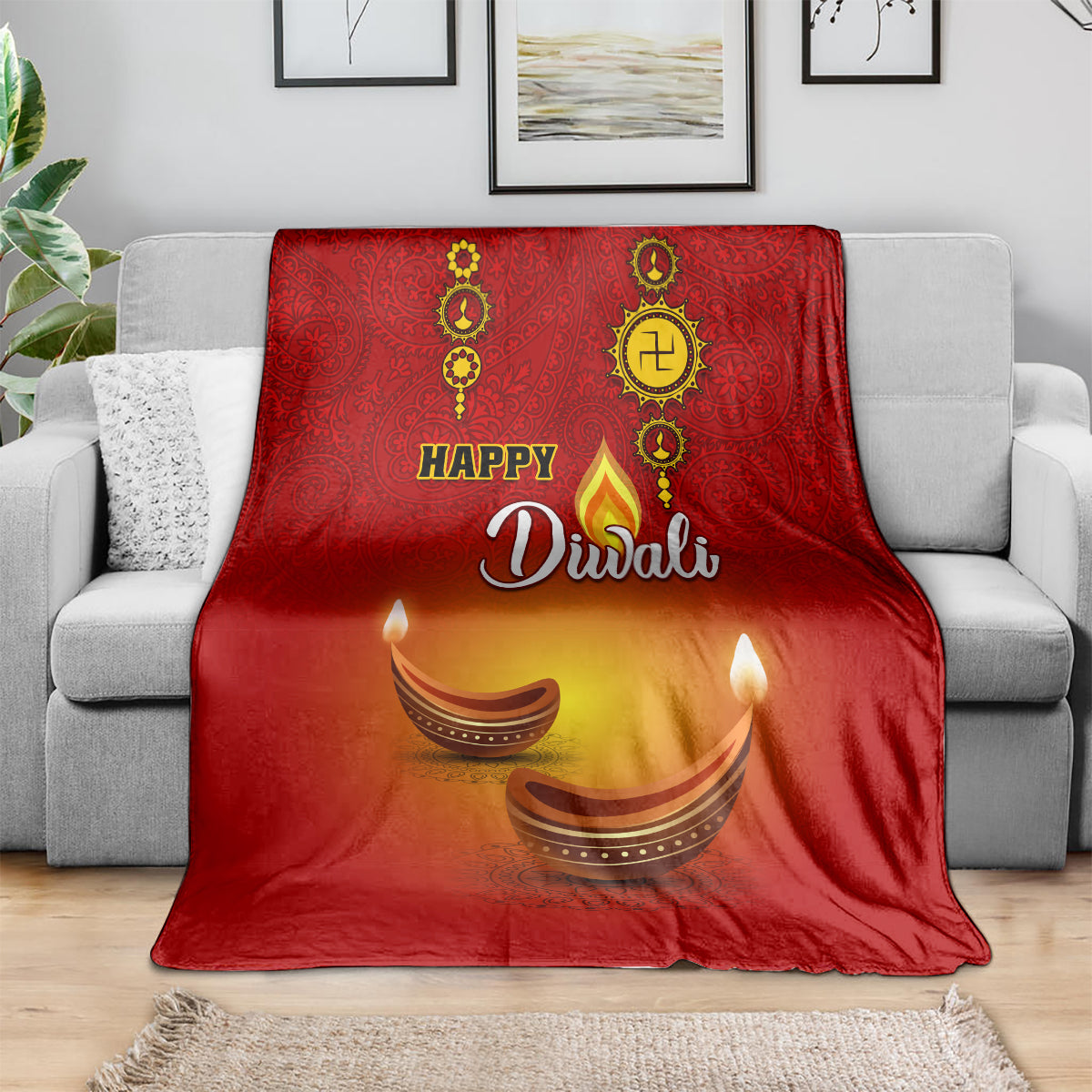 Red paisley Diwali blanket draped on a sofa, 'Happy Diwali' and diya graphics