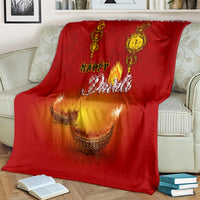 Red Diwali blanket with paisley border and glowing diya illustration
