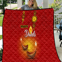 Red Diwali quilt with diamond quilting, Happy Diwali text, and diya candle icons