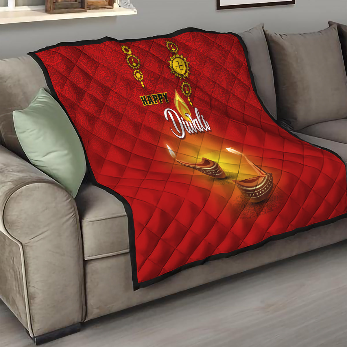 Red Diwali quilt on a sofa featuring Happy Diwali text and diya candle flames
