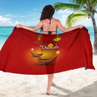Red Diwali sarong with paisley pattern and diya print, draped across shoulders