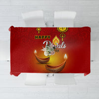 Red Diwali tablecloth with diya and paisley pattern, folded-edge view on chairs.