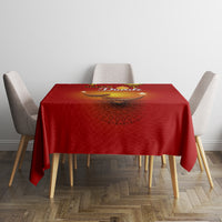 Red tablecloth with diya artwork and paisley motif, neatly set on dining table.