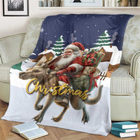 Christmas throw blanket on sofa with Santa and reindeer, 'Christmas' script, navy and white