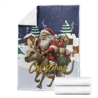 Christmas blanket folded with Santa and reindeer, 'Christmas' script, dark blue top and white roll